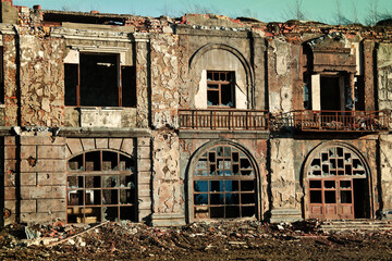 Landscape of ruined buildings at sunset, image of decrepitude or natural disaster.