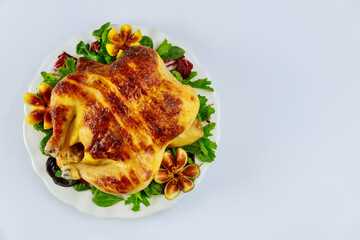 Top view baked chicken on plate with salad and figs on white isolated background.
