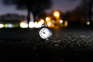 Old antique pocket watch showing time with blurred background
