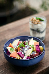exotic mixed tropical asian fruit salad in bowl outdoors