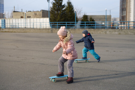 A child is riding a skateboard in autumn. Activity during the coronavirus period