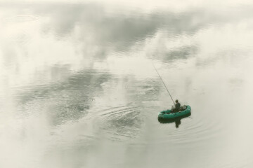 fisherman in a rubber boat on the water