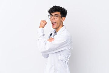 Young Argentinian man over isolated white background wearing a doctor gown and making strong gesture