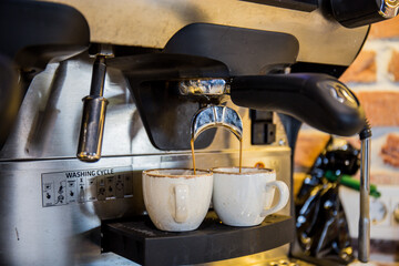 Coffee machine in restaurants and cafes, pouring coffee into cups