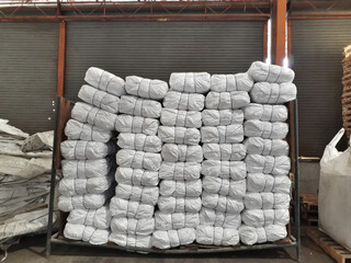 Old hemp sacks placed on pallets inside the warehouse.