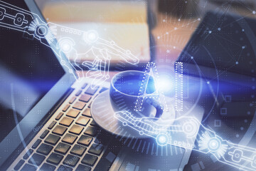 Double exposure of desktop computer and technology theme hologram. Concept of software development.
