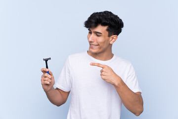 Man shaving his beard over isolated white background and pointing it