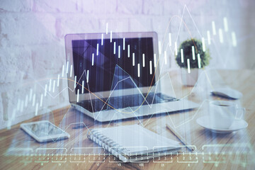 Financial graph colorful drawing and table with computer on background. Multi exposure. Concept of...
