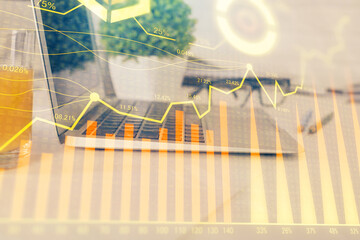 Forex Chart hologram on table with computer background. Multi exposure. Concept of financial markets.