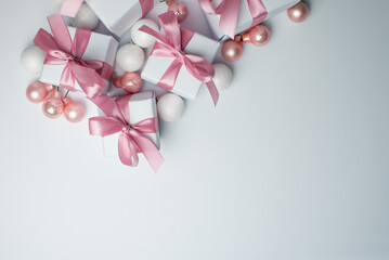 White gifts with pink ribbons. Set of gift box isolated on white background.Christmas gift boxes on white background. Beautiful Christmas background with shiny balls and ribbons in pastel pink color. 