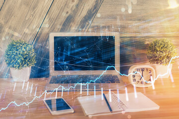 Multi exposure of graph and financial info and work space with computer background. Concept of...
