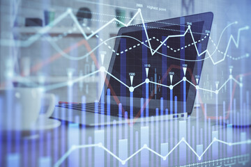 Stock market graph and table with computer background. Double exposure. Concept of financial analysis.