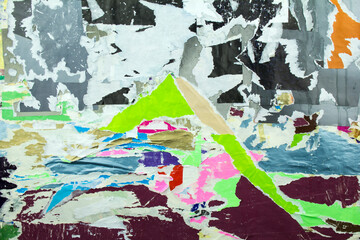 Torn and peelind old posters. Abstract background of ripped pieces of paper.