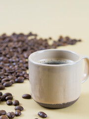 a cup of coffee on the background of coffee beans. close up