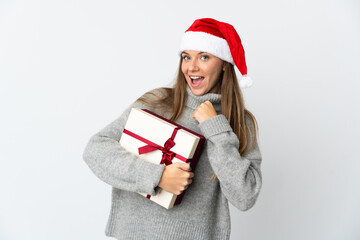 Lithianian woman with christmas hat holding presents isolated on white background celebrating a victory