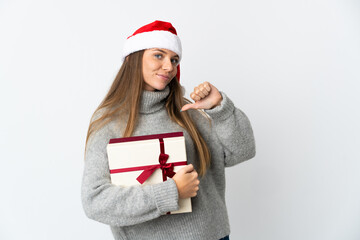 Lithianian woman with christmas hat holding presents isolated on white background proud and self-satisfied