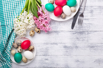 Easter eggs, pink and white hyacinth on wooden background. Easter concept. Top view. Copy space