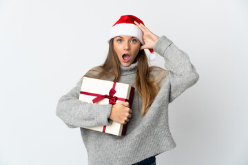 Lithianian woman with christmas hat holding presents isolated on white background with surprise expression