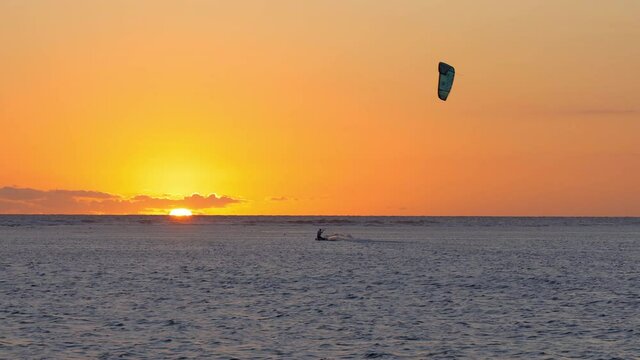 Man kitesurfing at sunset on Reunion Island