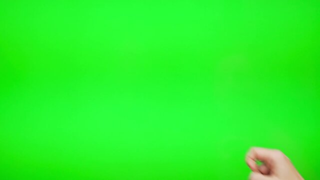 The Finger of the Female Hand Slides Flips from Right to Left on the Green Background Screen of the Chromakey Touch Digital Device. Using a Touch Device to View Video Content Blogging Surfing Internet