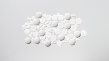 Various white medical pills on white background