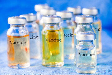 Corona virus and Covid - 19 new vaccine in ampules, different color variations of vaccine