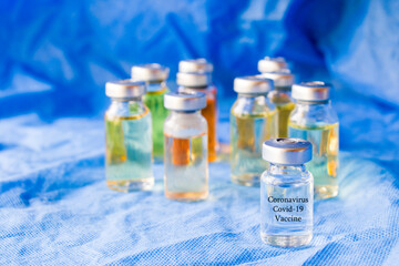 Corona virus and Covid - 19 new vaccine in ampules, different color variations of vaccine