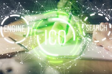 Cryptocurrency hologram, bitcoin, ico theme over hands taking notes background. Concept of...