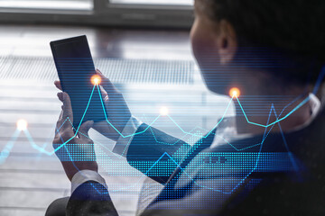 Businesswoman typing phone, work in modern office on new project. Financial graph hologram. Double exposure. Concept of success.