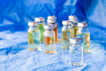 Corona virus and Covid - 19 new vaccine in ampules, different color variations of vaccine