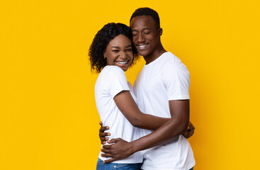 Beautiful african american couple posing on yellow