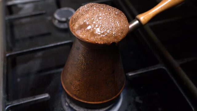 Close up of turkish coffee burning down on black background