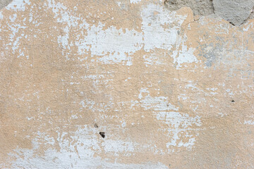 texture of brown old plaster on the street wall of the house. Warm shades