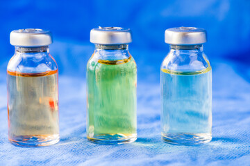 Corona virus and Covid - 19 new vaccine in ampules, different color variations of vaccine