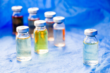 Corona virus and Covid - 19 new vaccine in ampules, different color variations of vaccine