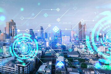 Glowing hologram of technological process, aerial panoramic cityscape of Bangkok at sunset. The...