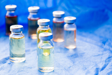 Corona virus and Covid - 19 new vaccine in ampules, different color variations of vaccine