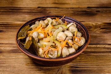 Canned mushrooms with carrot and onion in a ceramic bowl