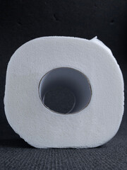 toilet paper roll on a dark background, hygiene items, essential goods during quarantine
