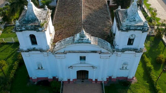 Panning over the facade of a catholic church in Danli, and with a nice sunrise light from behind