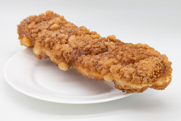 Long Fried Doughnut on a White Plate