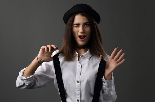 Beautiful Girl In A Black Hat And White Shirt With Suspenders