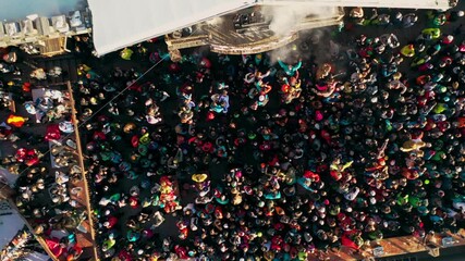 People partying to DJ at ski resort bar, aerial view