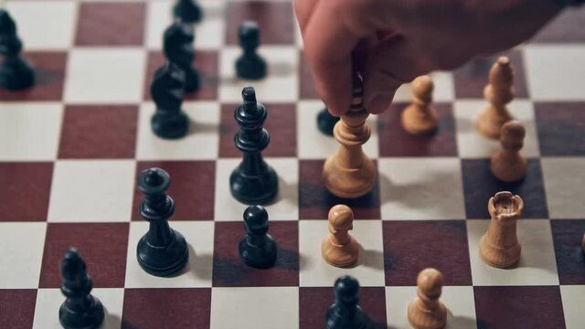 White king knocking over the black teams king, granting victory to the white team.