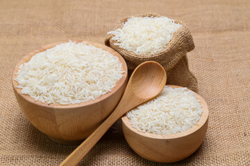 Fototapeta na wymiar rice in bowl on sack background