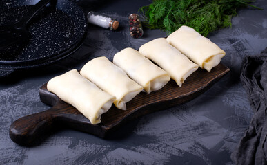 Raw rolled pancakes with filling ready to be roasted