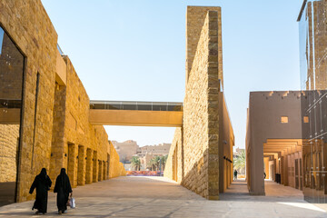 Arabic women walking in the Diraiyah, also as Dereyeh and Dariyya, a town in Riyadh, Saudi Arabia, was the original home of the Saudi royal family, and served as the capital of Emirate of Diriyah.
