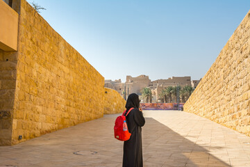 A woman wearing black hijab watching ruins of Diraiyah, also as Dereyeh and Dariyya, a town in Riyadh, Saudi Arabia