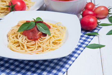 Spaghetti pasta with and tomato sauce on wood background