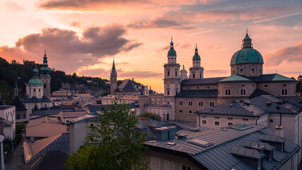 The skyline of Salzburg in Austria seen from the famous fortress Hohensalzburg with the cathedral during sunset